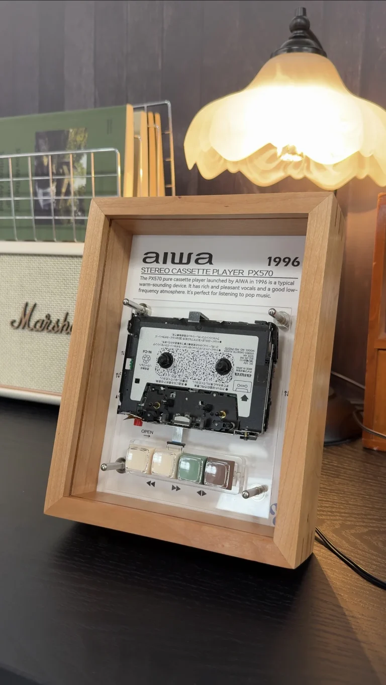Aiwa PX570 restored cassette player framed as playable wall art - real product photo