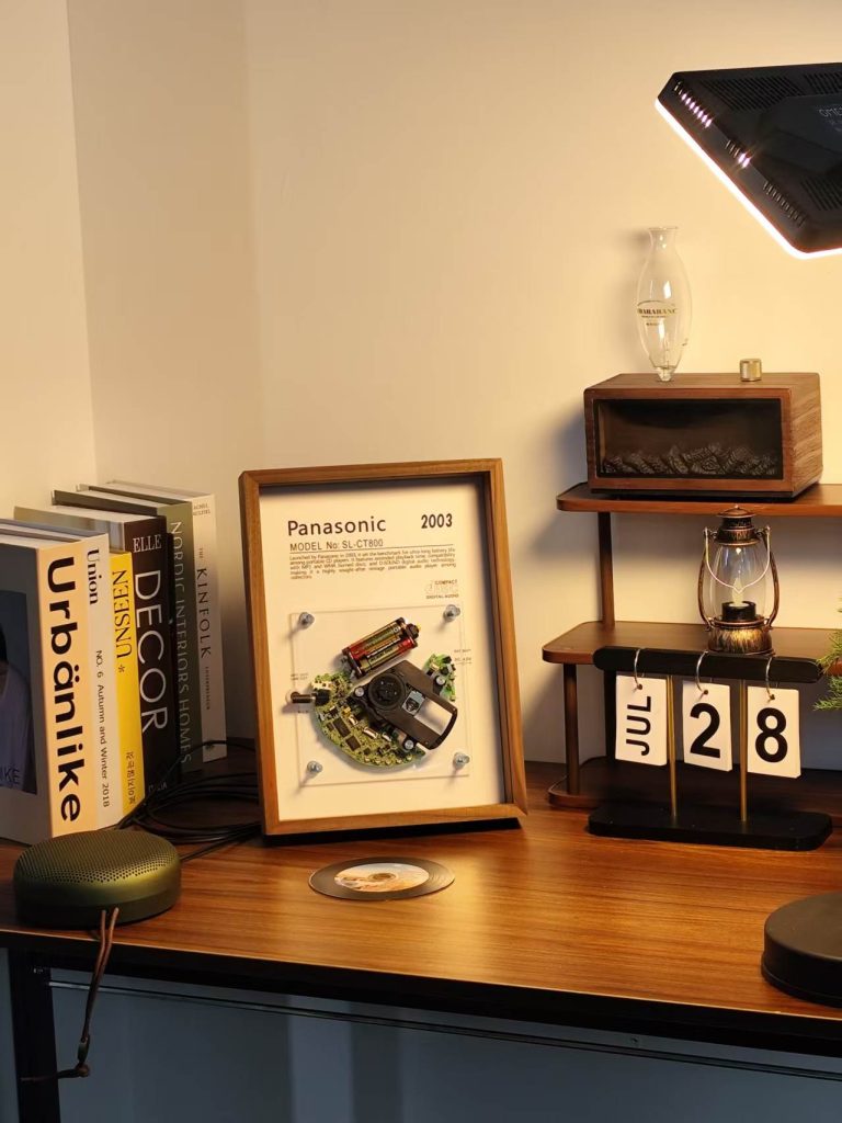 Framed restored Panasonic SL-CT800 CD player shown as retro wall art on a shelf
